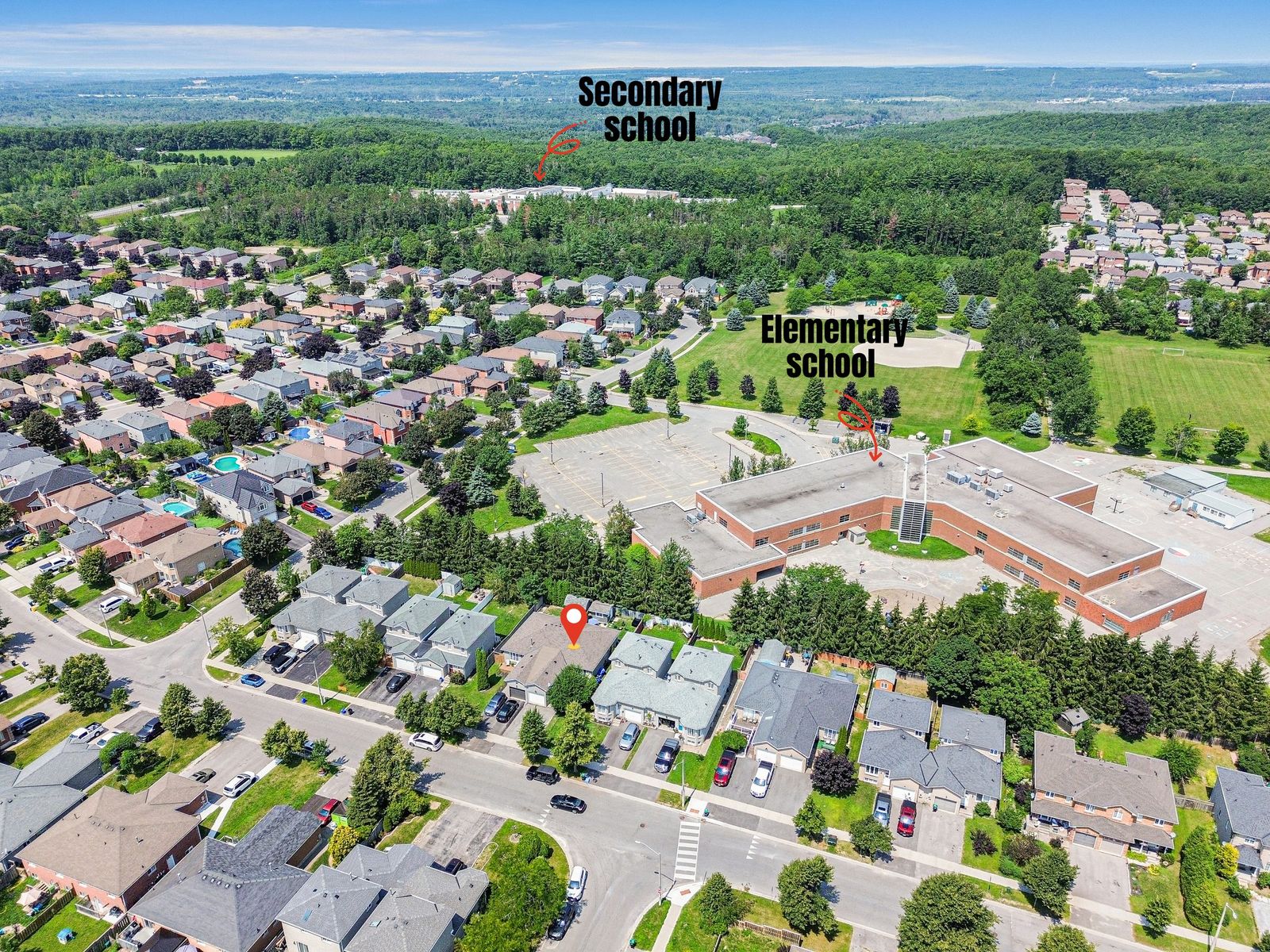 Drone aerial with neighbourhood amenity labels — schools marked for buyers