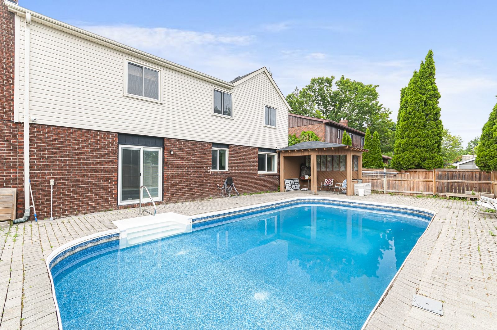 Backyard in-ground pool and landscaped patio