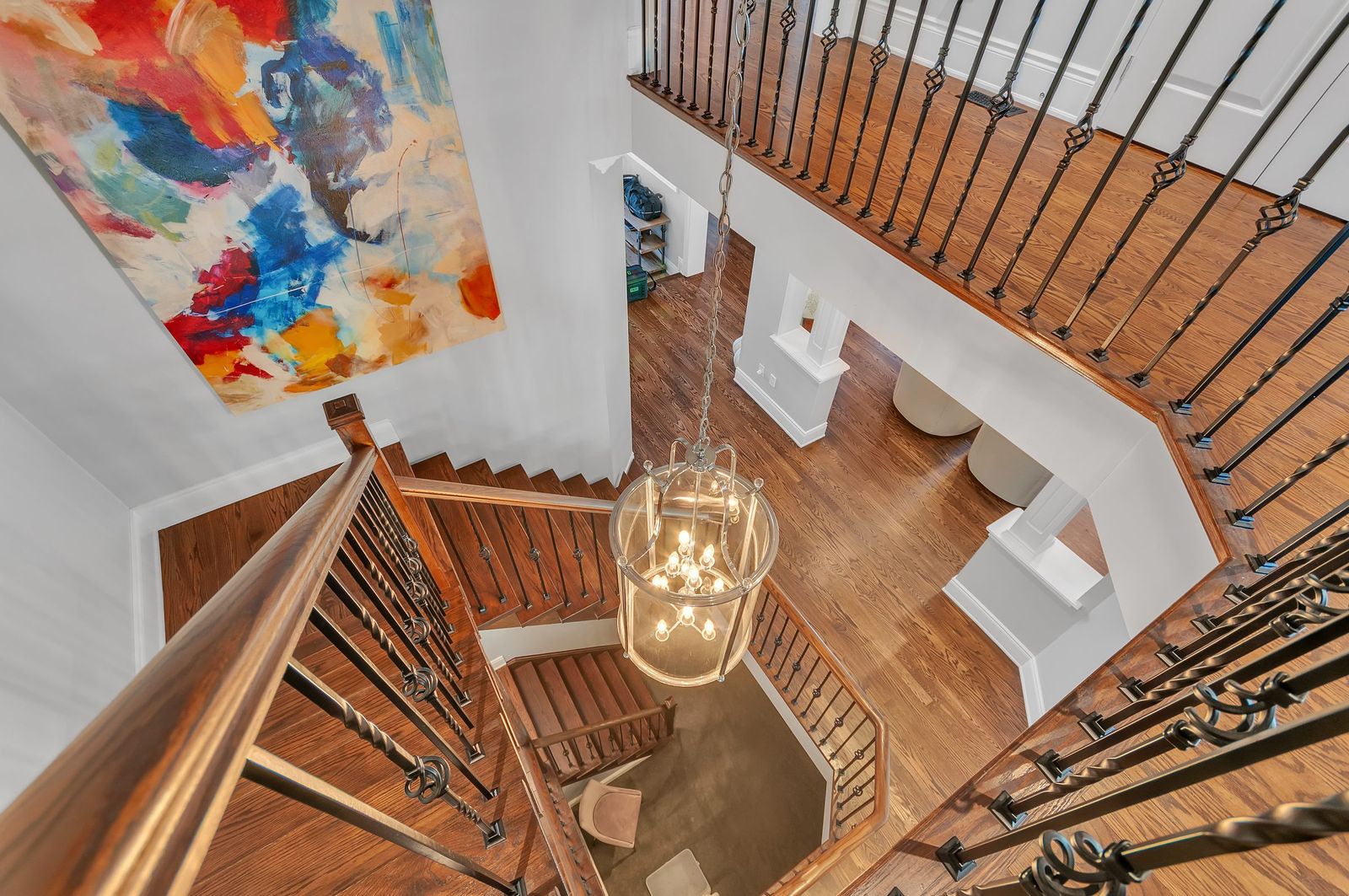 Overhead view of a curved staircase and chandelier