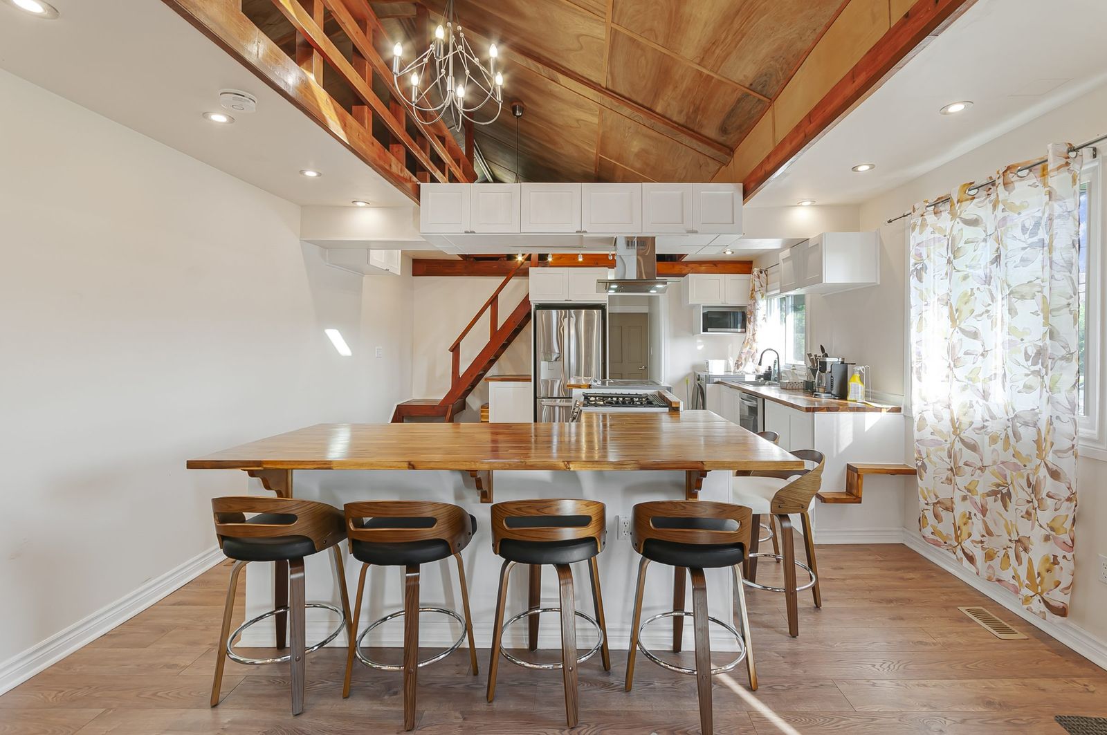 Open kitchen with wood cathedral ceiling and breakfast bar