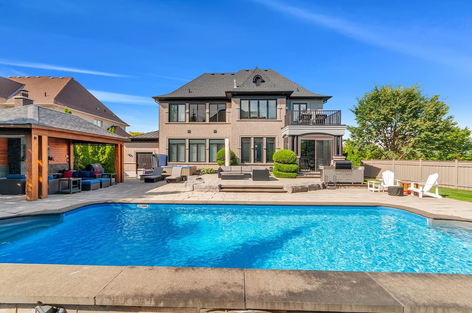 Backyard pool and rear elevation of an estate home, York Region real estate photography