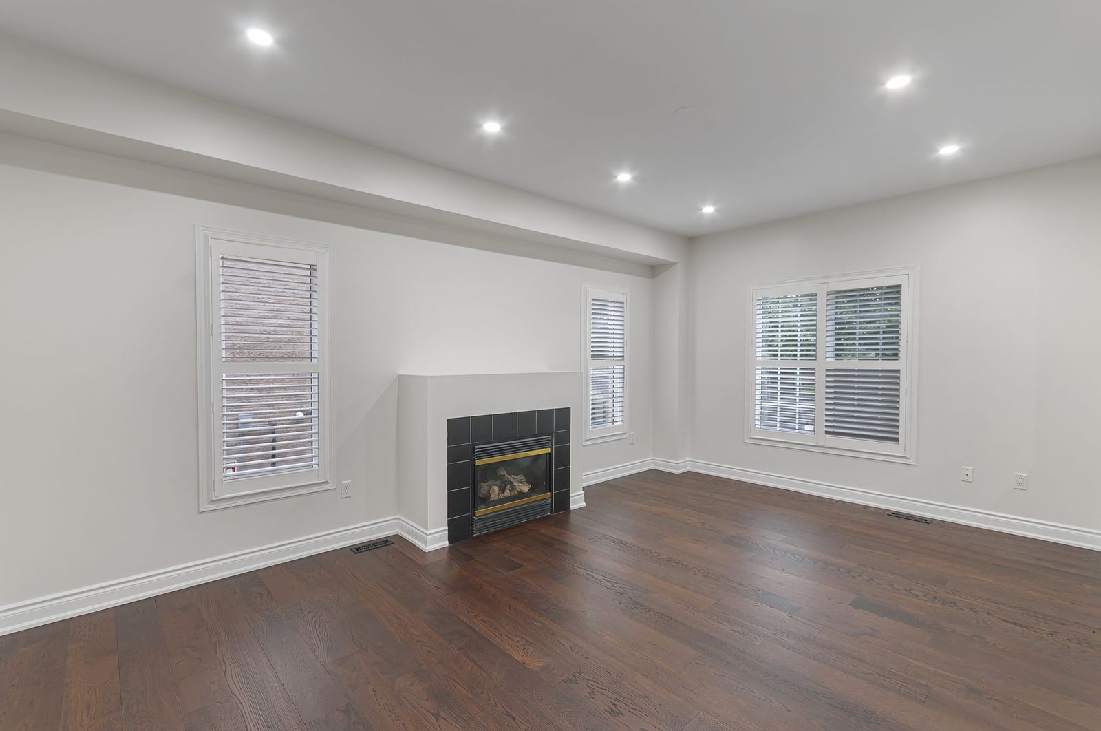 Living room with fireplace before virtual staging — empty room, Brampton listing