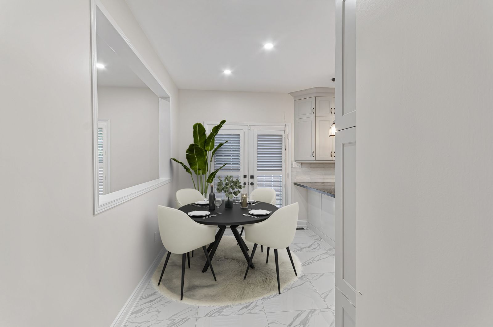 The same dining area off the kitchen after virtual staging — furniture and decor added