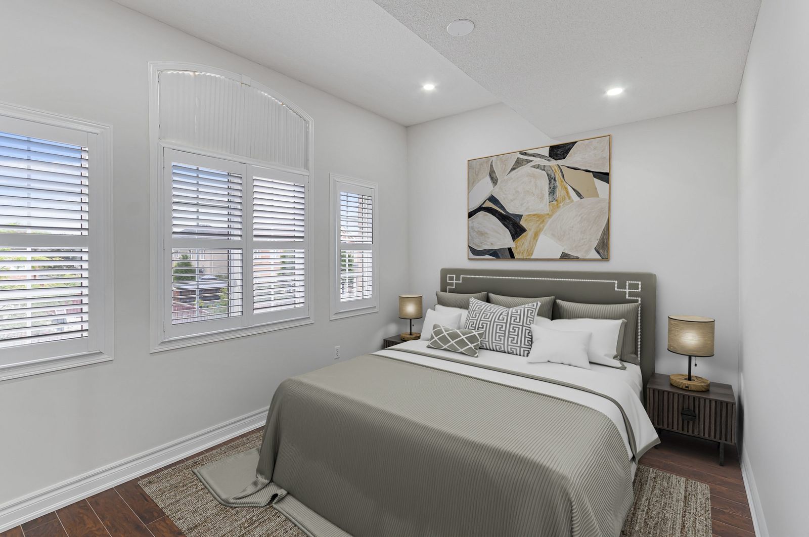 The same primary bedroom after virtual staging — furniture and decor added