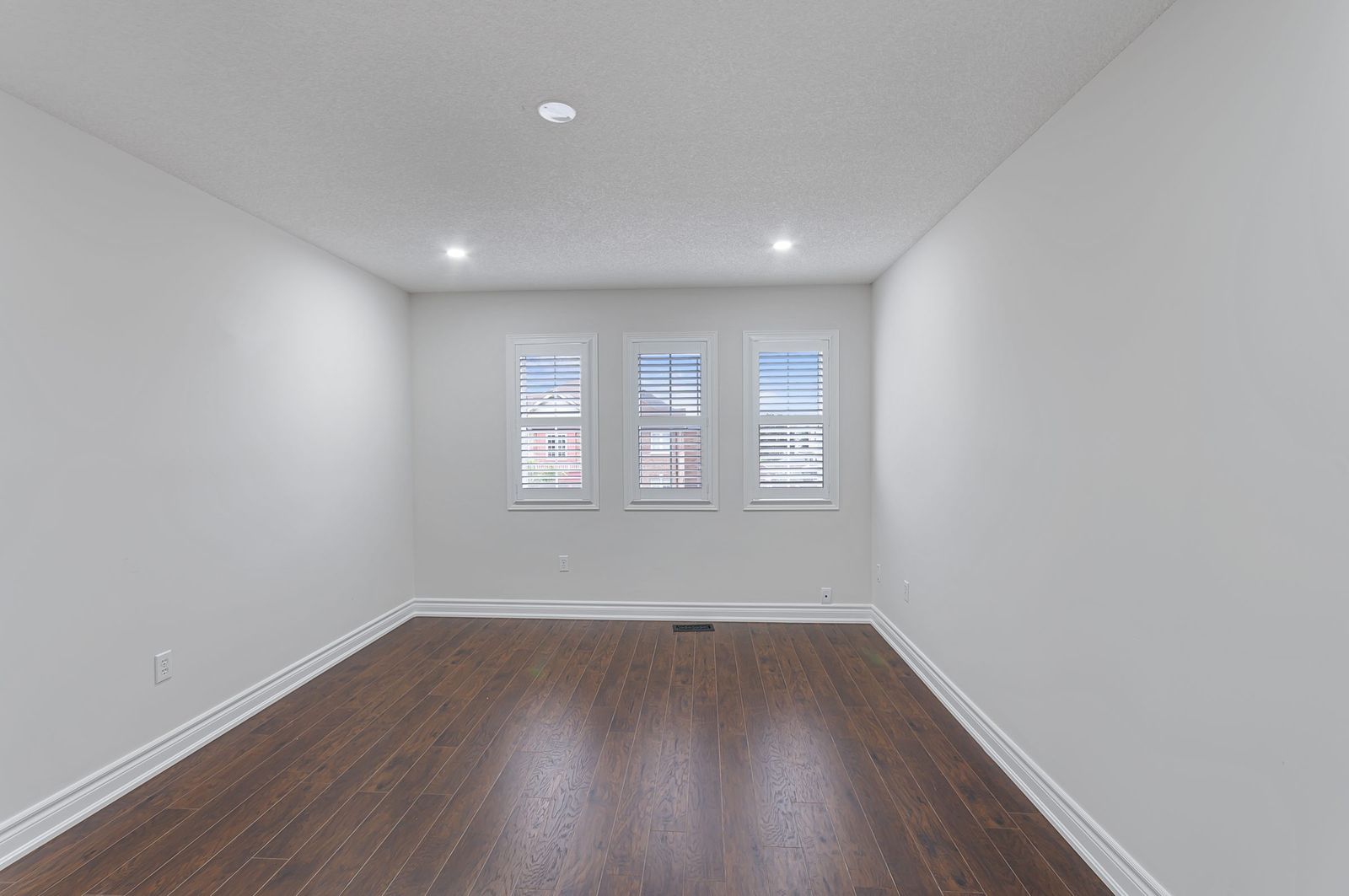 Bedroom with media wall before virtual staging — empty room, Brampton listing